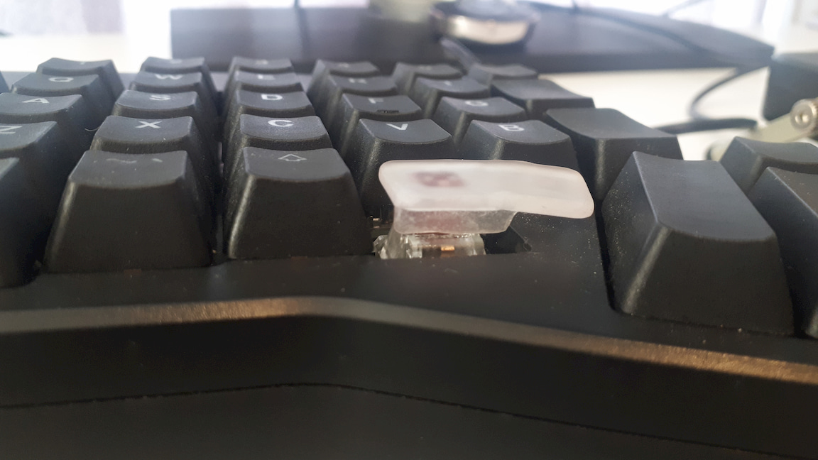 The keycap is still slightly skewed.