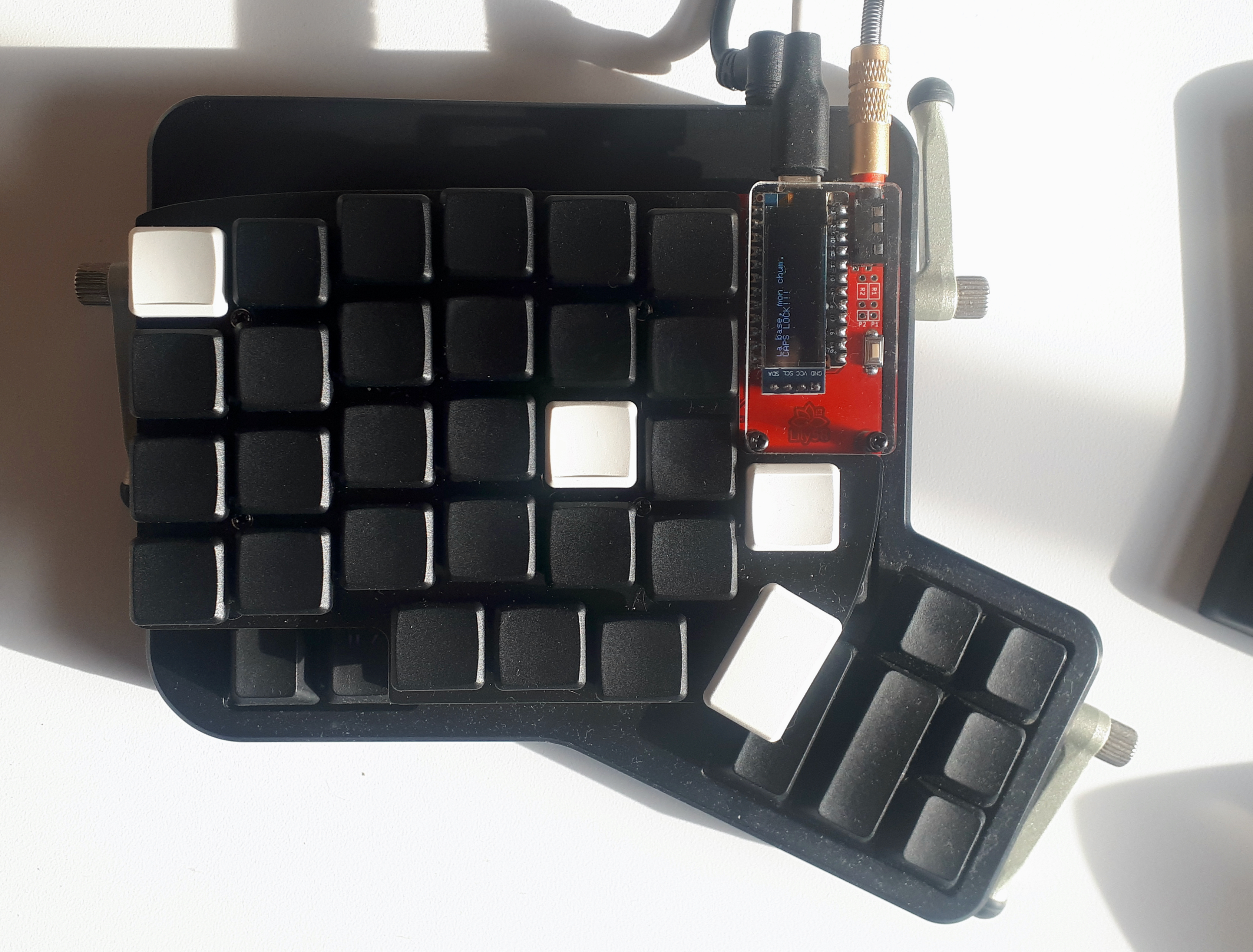 Lily58 on top of an Ergodox. Lily58 is smaller.